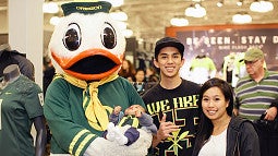 A family and the Duck at the UO Alumni event at the Nike story