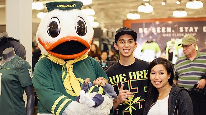 A family and the Duck at the UO Alumni event at the Nike story